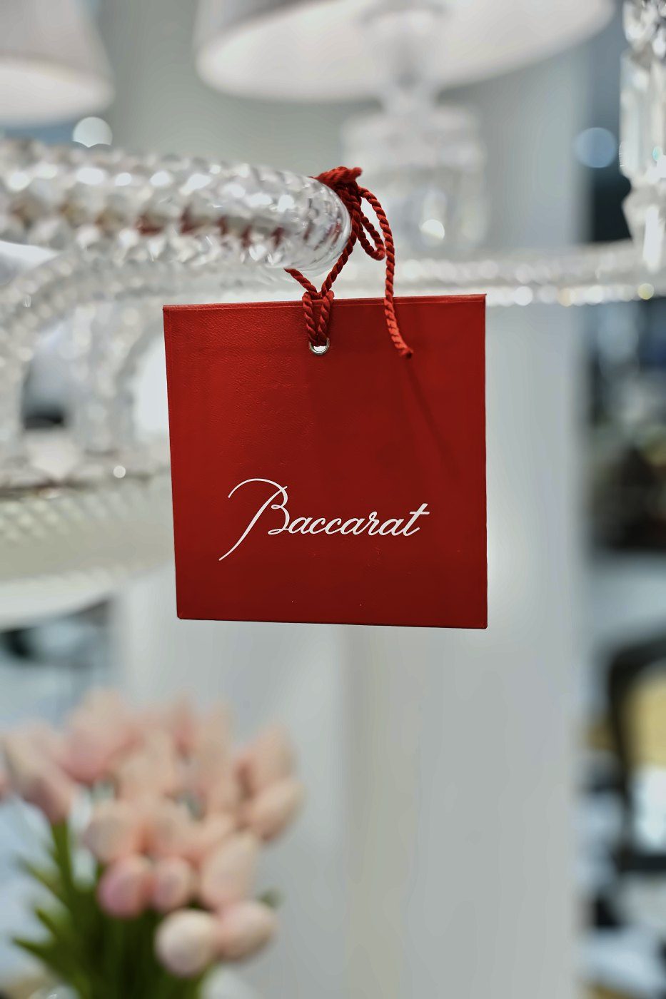 Red Baccarat tag on a crystal chandelier