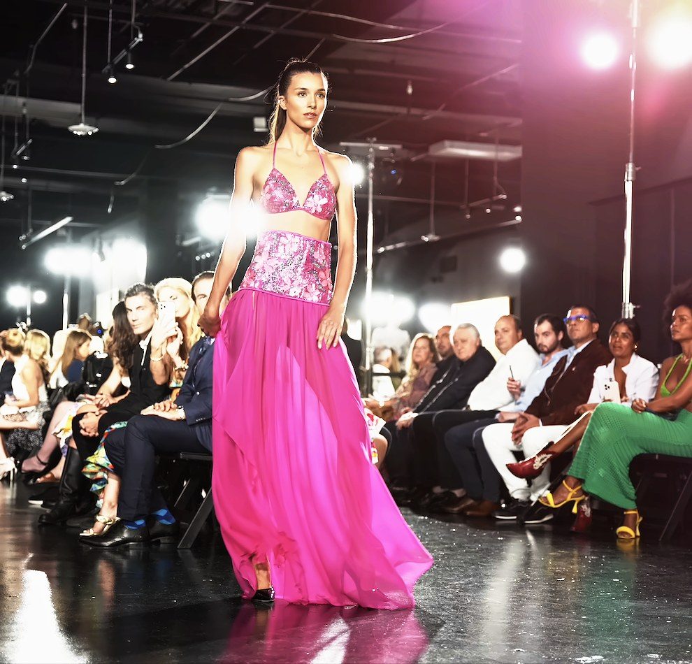Model walking the Miami Fashion Week runway in a pink sequin gown