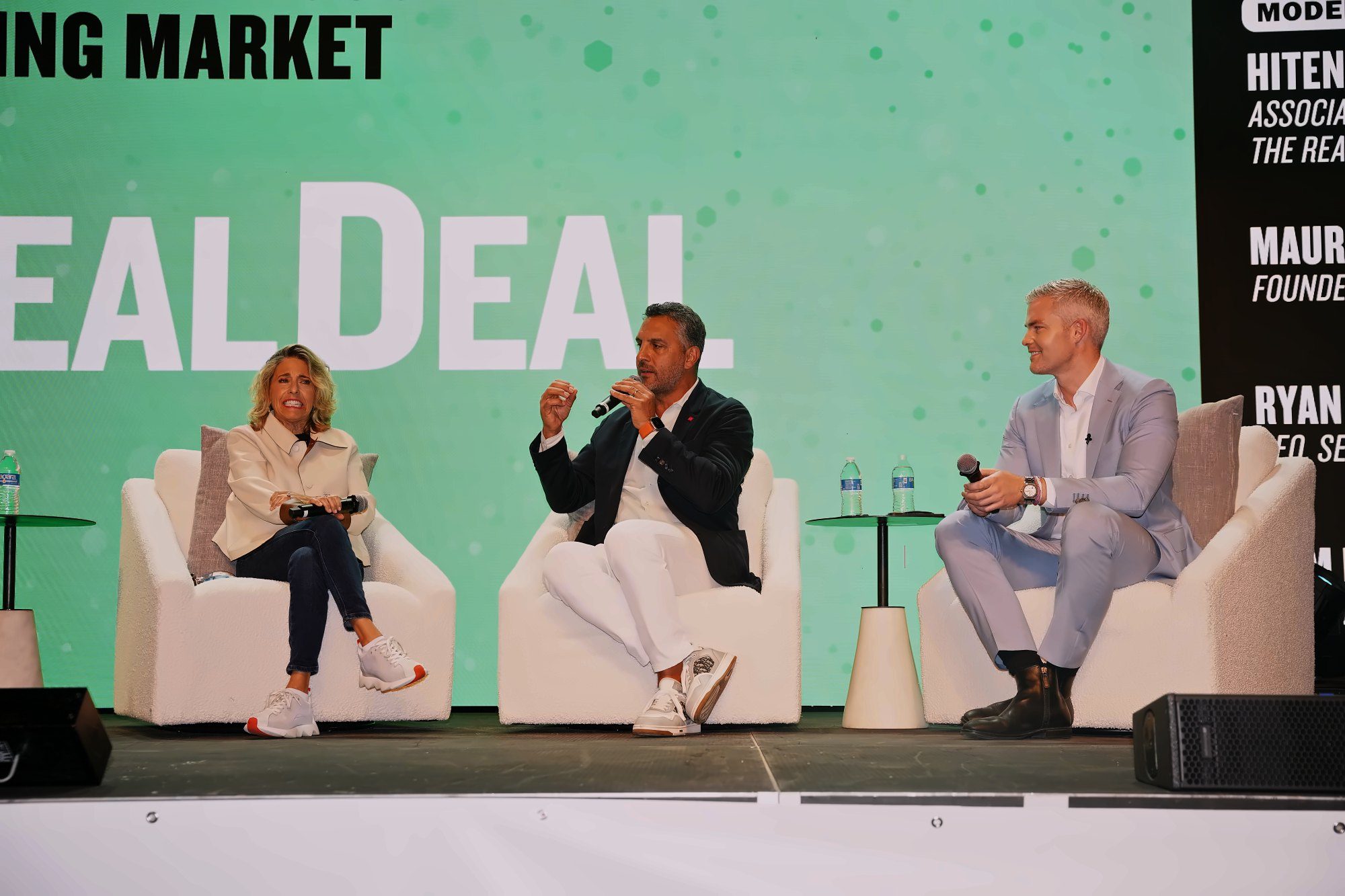 Panelists on stage at The Real Deal conference